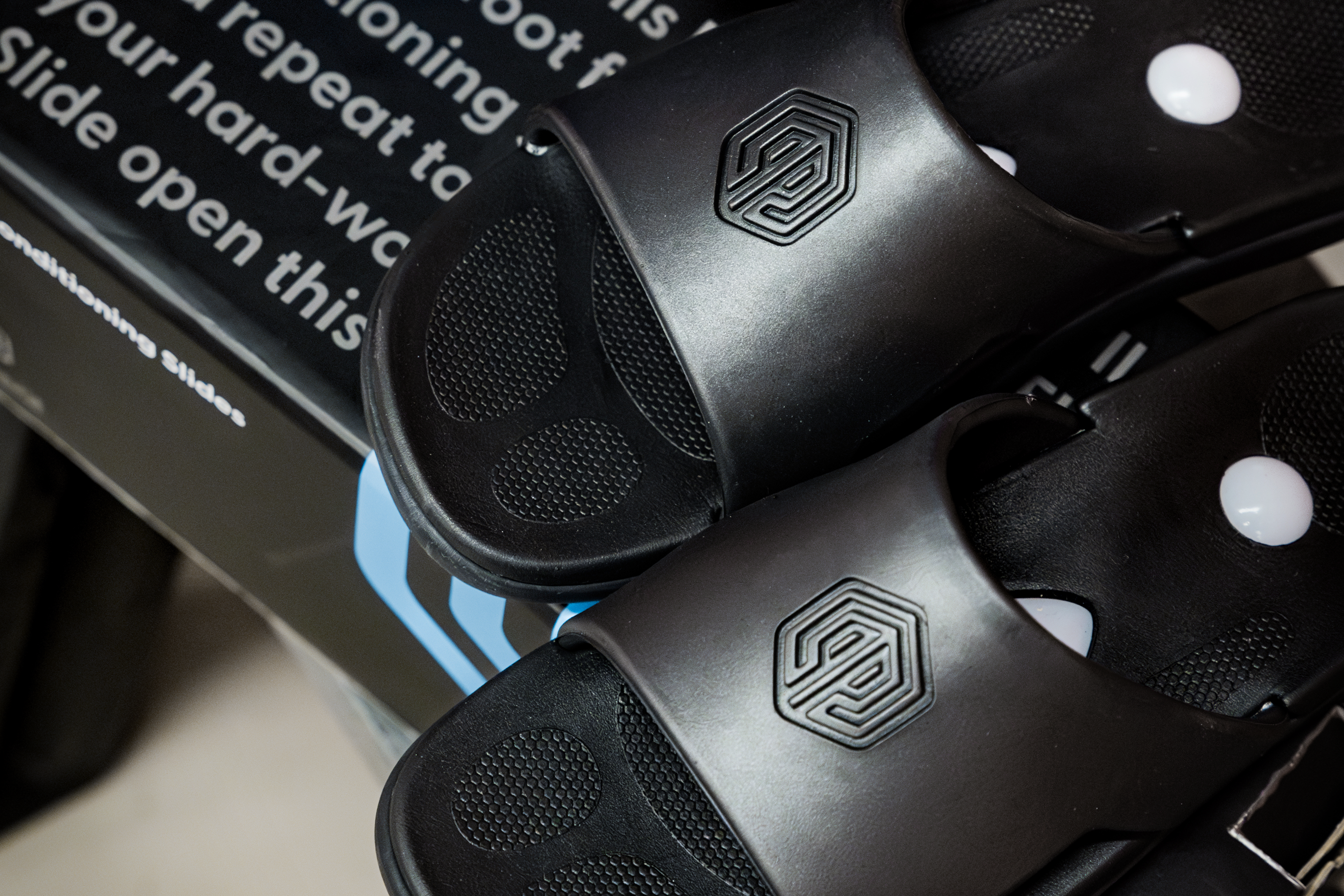 Pair of Flex 3 Fitness Slides poised atop Flex 3 Fitness Slides shoebox.