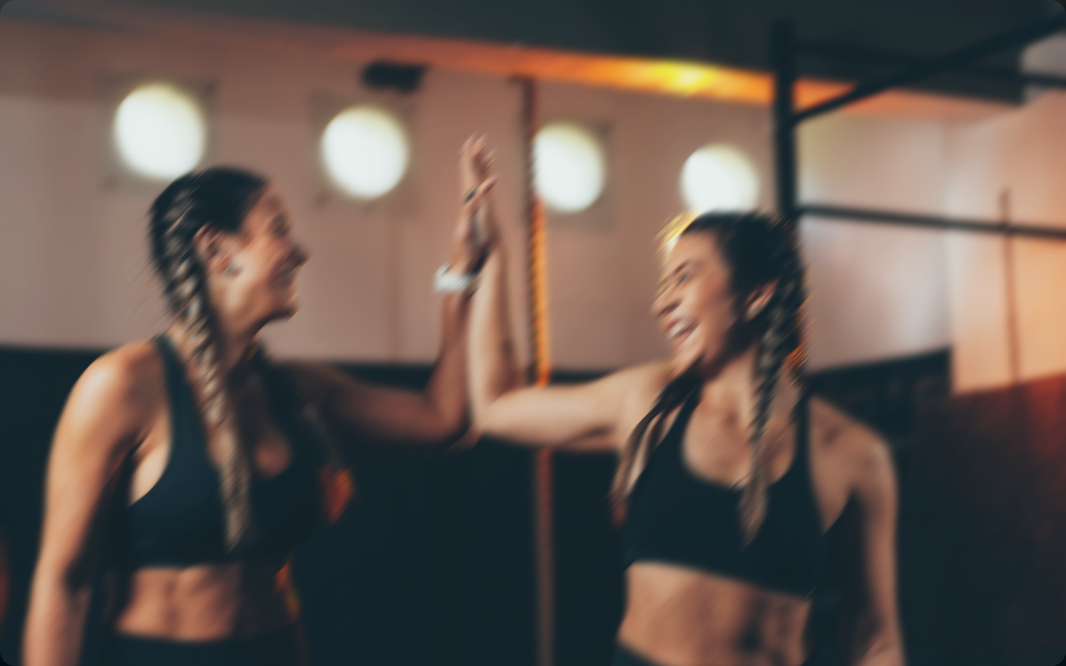 two girls high fiving after a workout