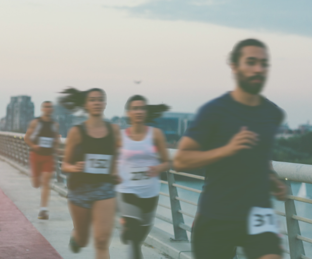 Group of 4 Marathon Runners On a Bridge