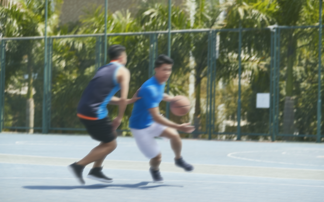 two people playing basketball
