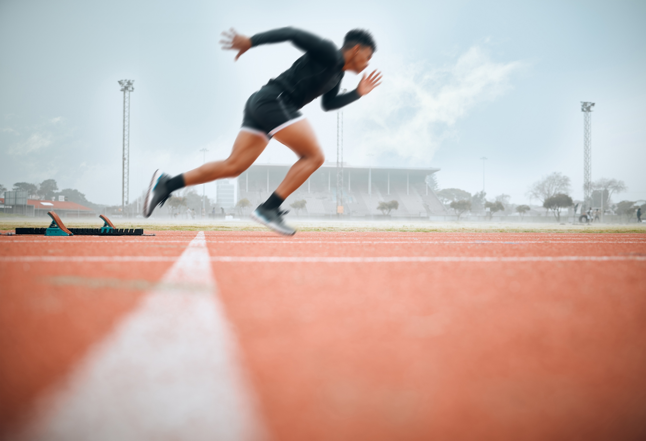 Person running on a track with a blurred background